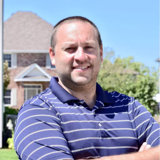 headshot of David Milton, wearing a blue and white stripped polo