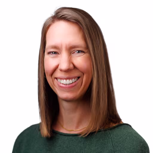 headshot of Erin Hill, wearing a green sweater