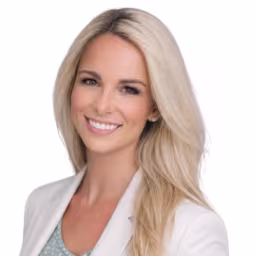 headshot of Jessica Leonhard, wearing a white blazer with a blue shirt