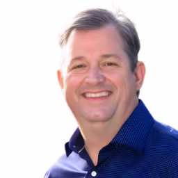 headshot of Mark Gorman, wearing a blue polo