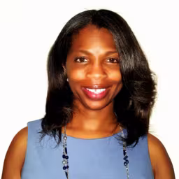 Headshot of Stephanie Hamilton wearing light blue sleeveless shirt with white background