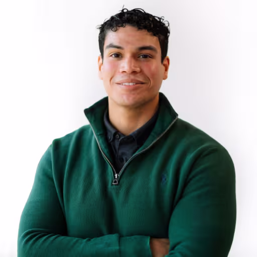 headshot of Antonio Madera, wearing a green pull over sweater