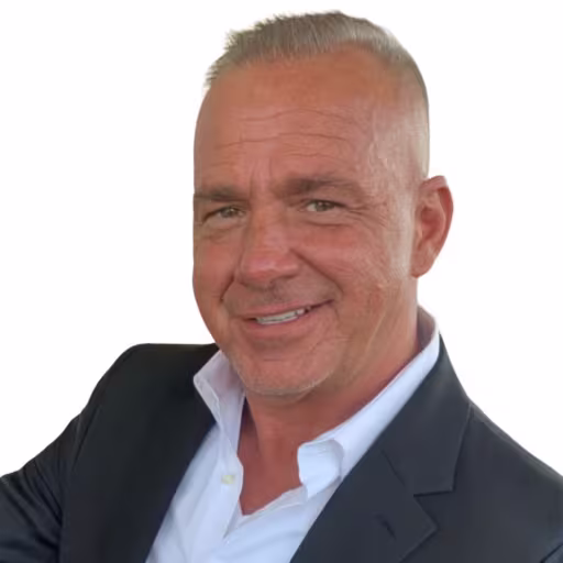 headshot of Brian Hiner, wearing a white shirt and black blazer