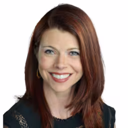 Pam Chamness in black top with white background