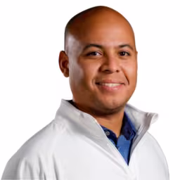 headshot of Adrian Moreno, wearing a white pull over with a blue shirt