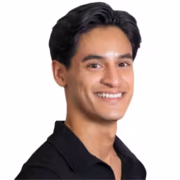 Headshot of Luis Quintanilla, wearing a black shirt