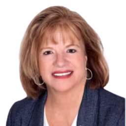 headshot of Mary Lawrence, wearing a dark blue blazer and white shirt