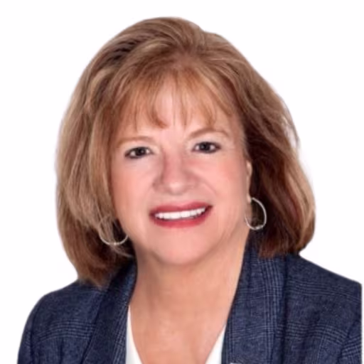 headshot of Mary Lawrence, wearing a dark blue blazer and white shirt