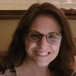 Headshot of Maria Klima with brown background