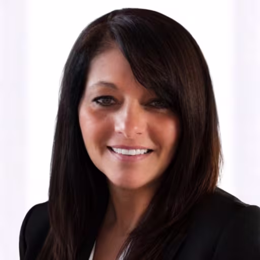 headshot of Gina Talanca, wearing a black blazer and striped shirt