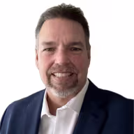Man wearing navy suit jacket and white button down