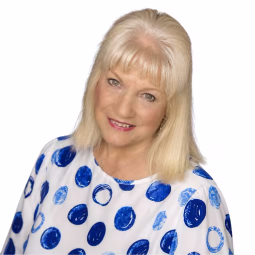 headshot of Darleen Hill, wearing a blue and white polka dot shirt