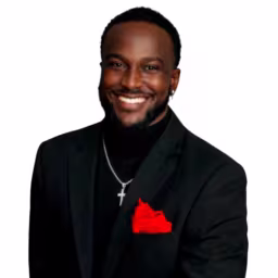 Headshot of Marlon Mitchell II wearing black shirt and suit coat, a red hankerchief in the pocket with white background