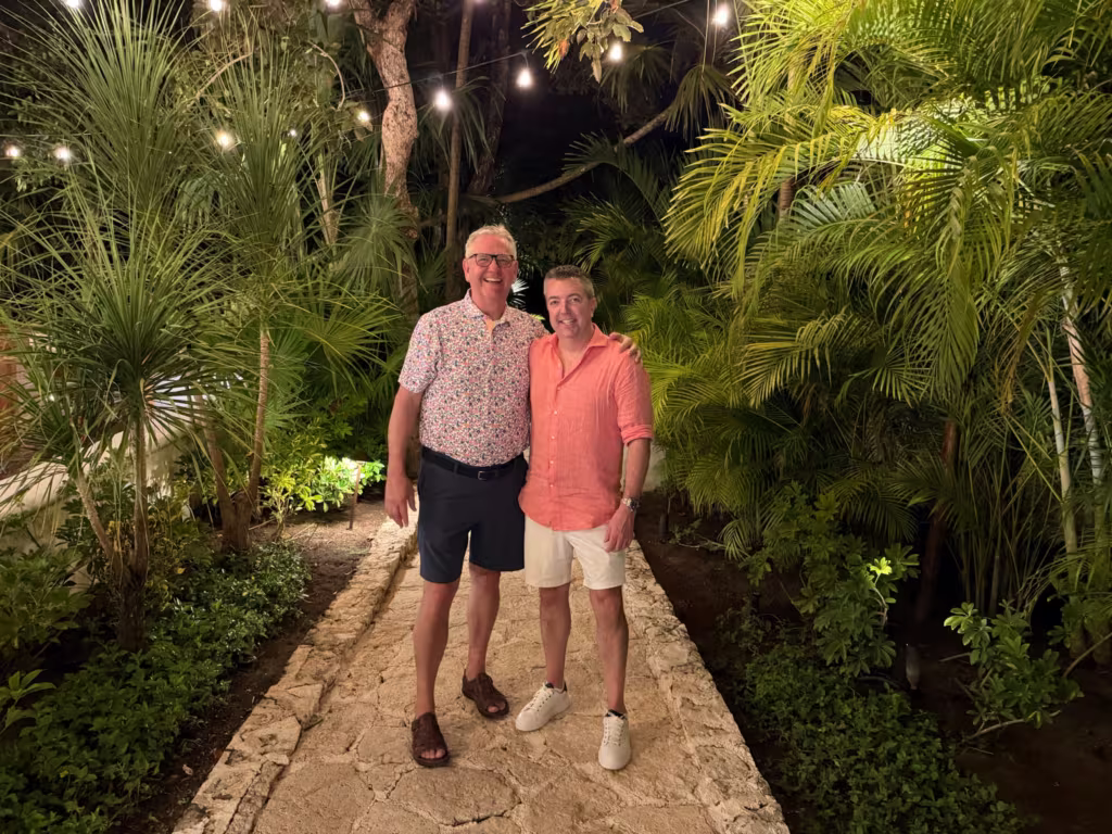 Brian Jensen, National Sales Director, and Eric Egenhoefer, CEO, posing for a photo in a tropical place