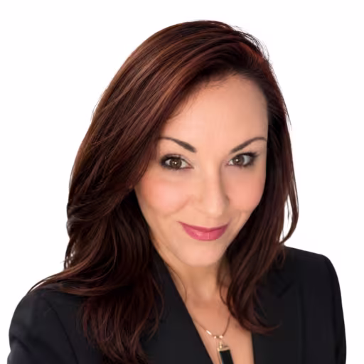 Headshot of Kelly Luna wearing black suit coat with white background