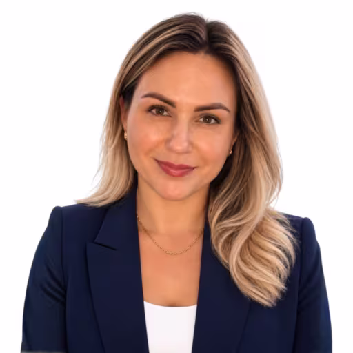 headshot of Ksusha Villegas, wearing a dark blue blazer and white shirt
