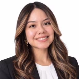 Headshot of Nicole Rios, wearing a black blazer and white shirt