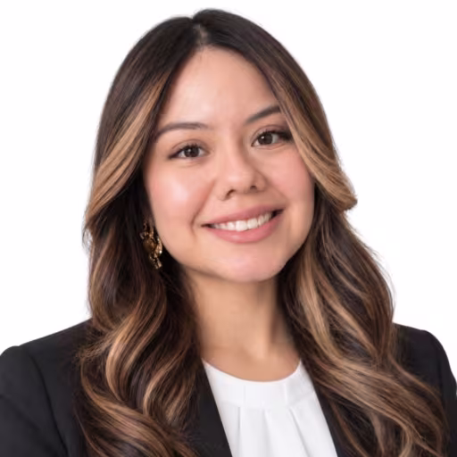 Headshot of Nicole Rios, wearing a black blazer and white shirt