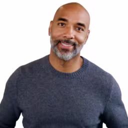 headshot of Eddie Jackson, wearing a gray sweater