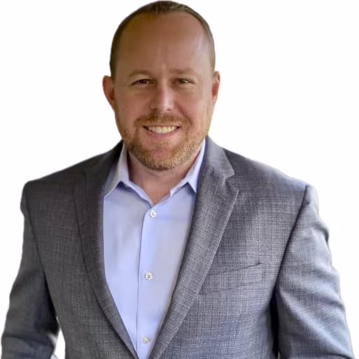 headshot of Robert Grimes, wearing a gray suit with a light blue shirt