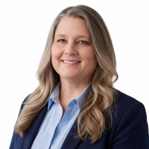 headshot of Stephanie Taylor, wearing a black blazer and light blue shirt